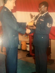 Males greeting each other in military uniforms