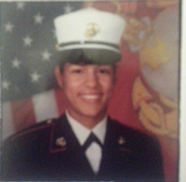 Woman in military uniform in front of American flag