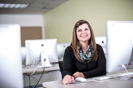 Woman in computer lab smiling